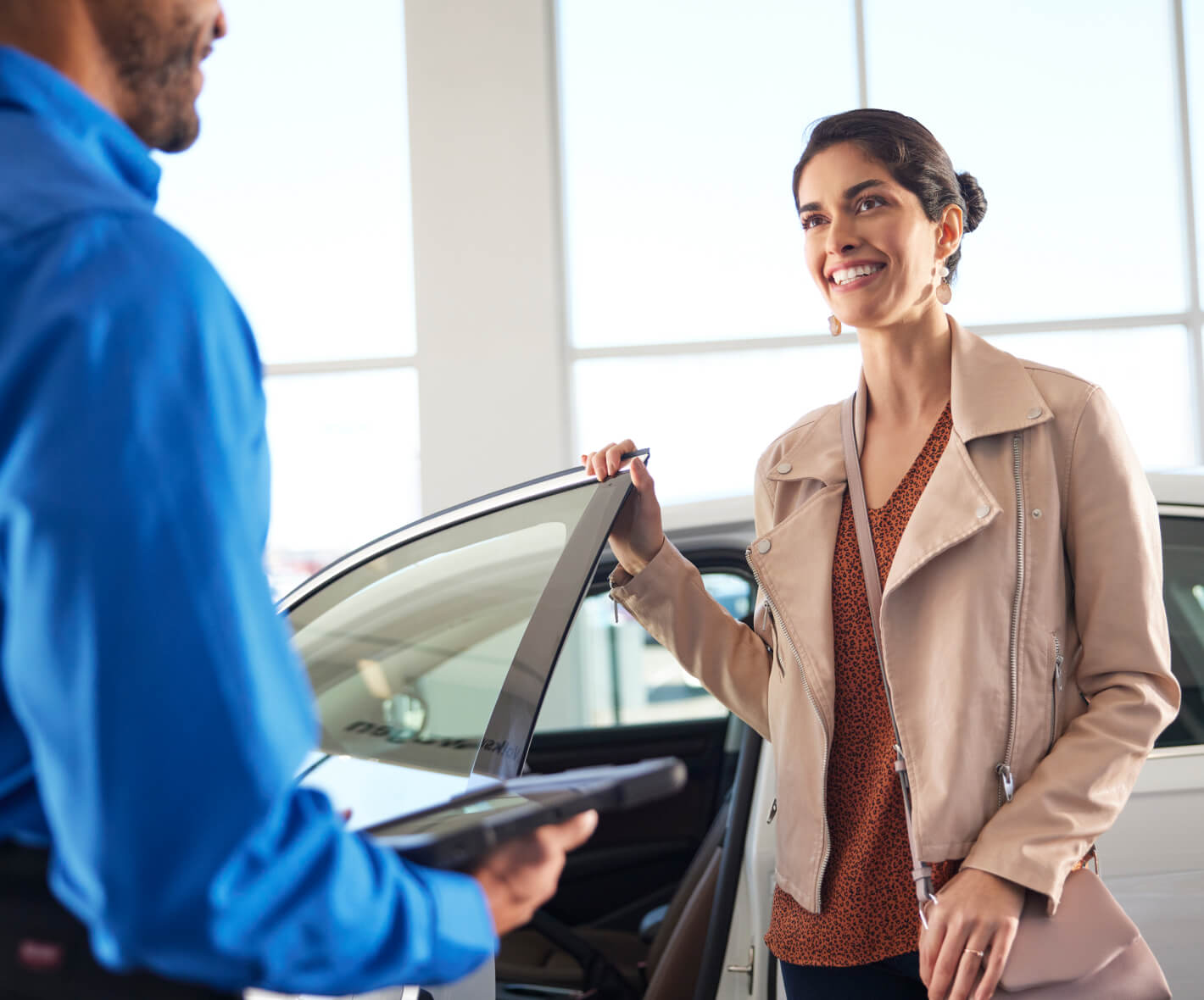 Customer Speaking with Sales Associate while Browsing New Vehicles