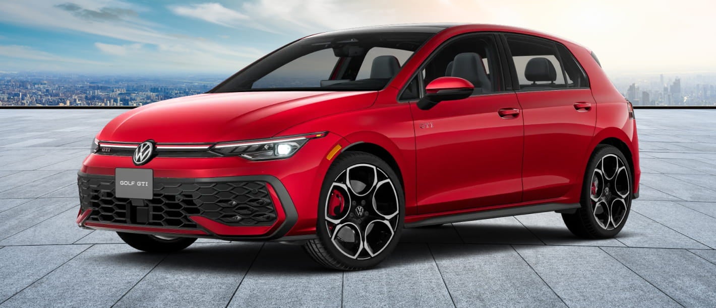 Red 2026 Volkswagen Golf GTI on a rooftop with a city skyline backdrop. The car's sleek design, large alloy wheels, and sporty stance convey a dynamic feel.