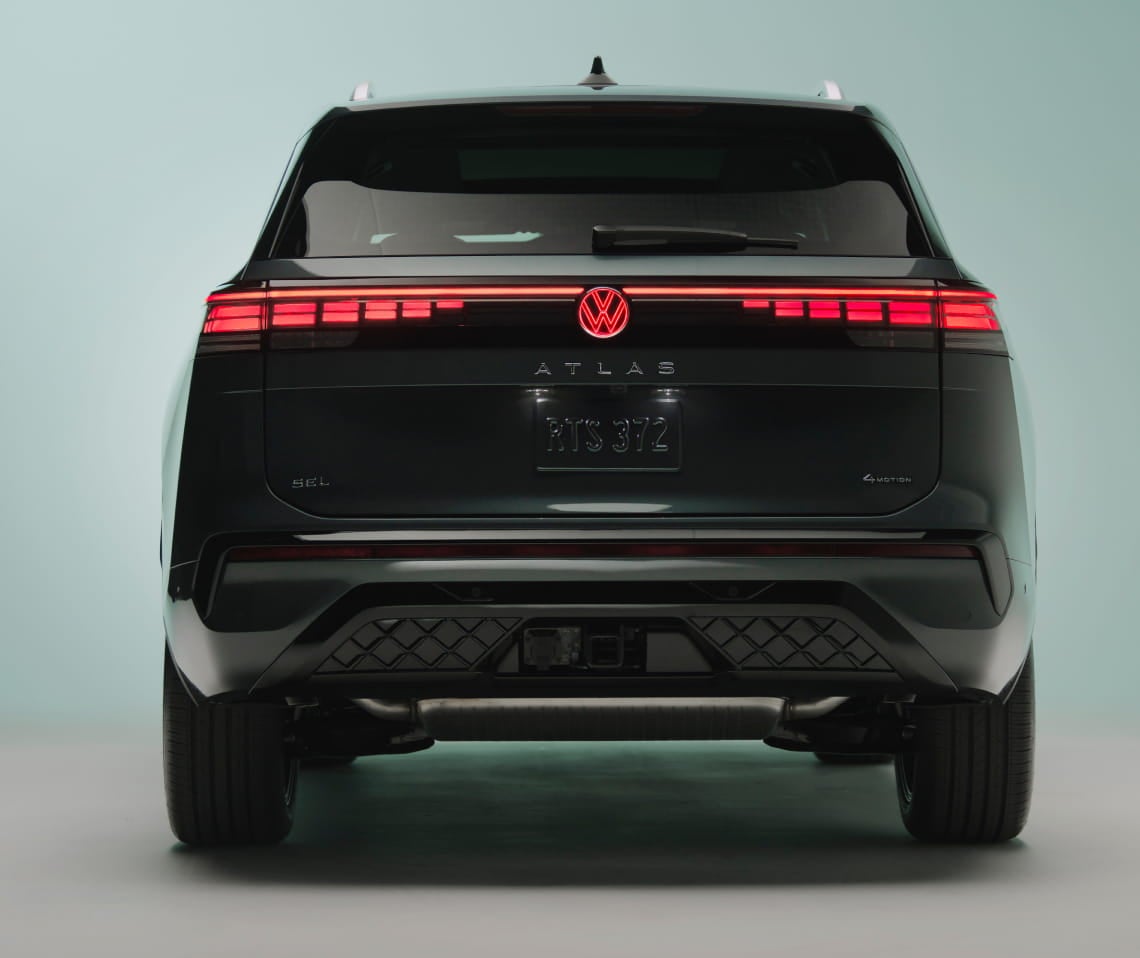 Rear view of a Volkswagen Atlas with illuminated LED taillights and Volkswagen emblem.