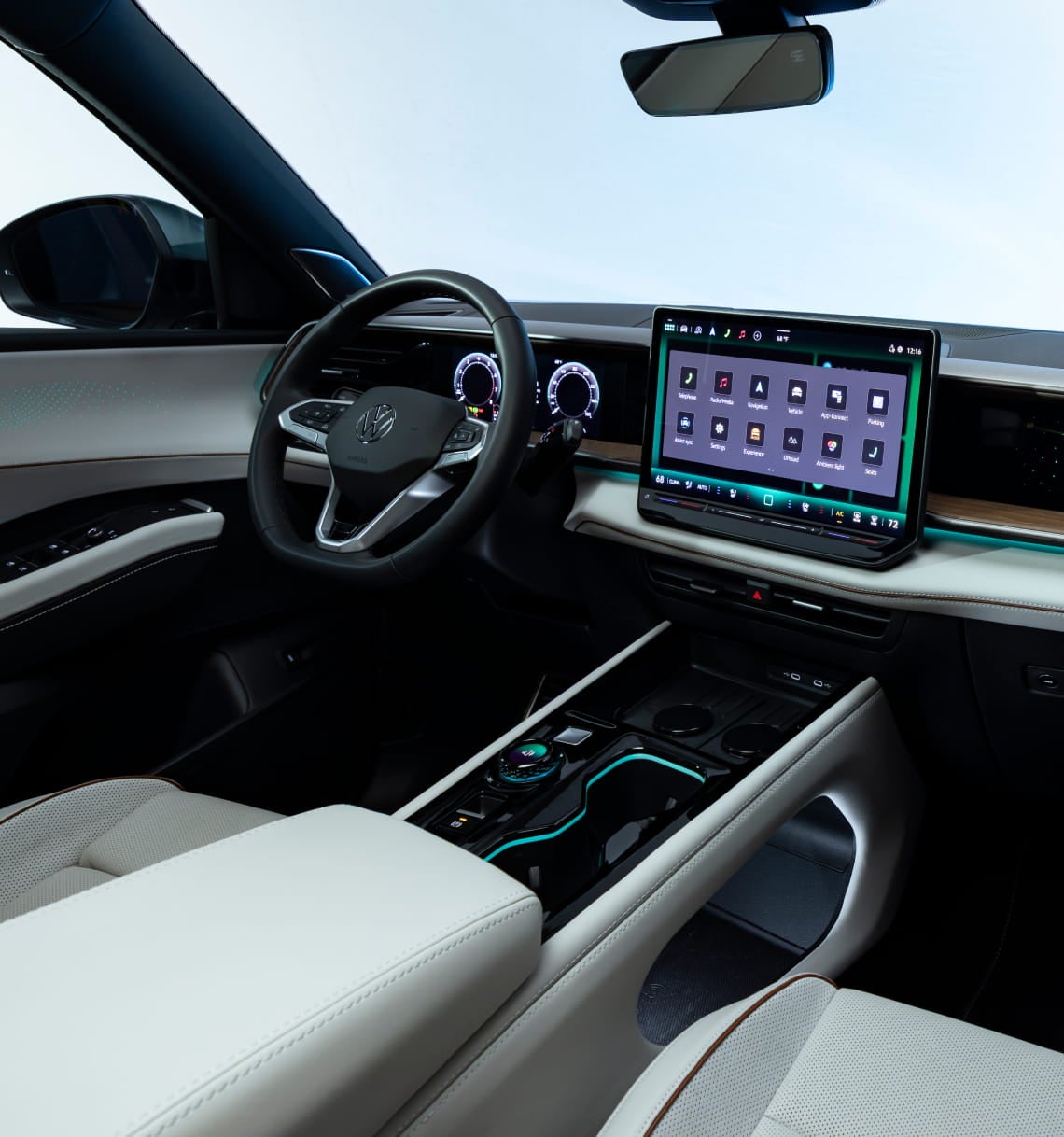 Volkswagen Atlas cockpit with digital instrument cluster, large center touchscreen, steering wheel, and ambient lighting.